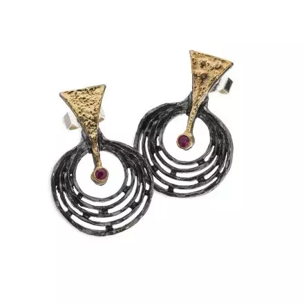 Earrings composed of a darkened antique finish Silver Circle hanging from a dangling Silver Triangle adorned with 18k Gold Leaves and Ruby