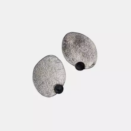 Uniquely textured, oval clip-on Silver Earrings with small darkened, antique finish circle at the side